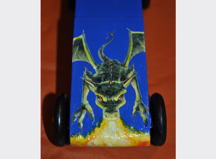 Custom paint job for my younger son's Pinewood Derby Car. Sadly, the fire-breathing dragon didn't move as fast as the previous year's car. Acrylic paint on wood.